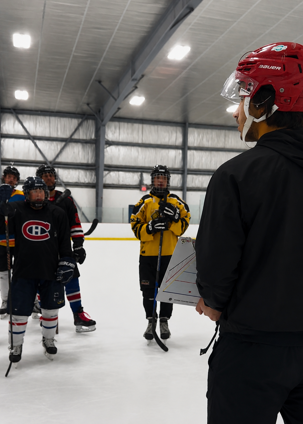 Forge Hockey coach teaching players on the ice